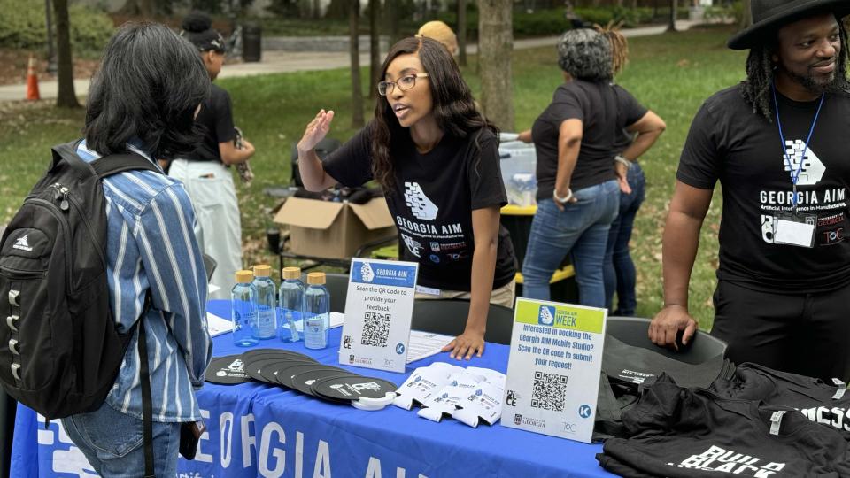 Georgia AIM representatives talk with students on Georgia Tech&#039;s campus during the launch event for their new mobile labs.