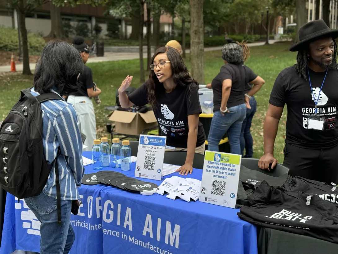 Georgia AIM representatives talk with students on Georgia Tech&#039;s campus during the launch event for their new mobile labs.