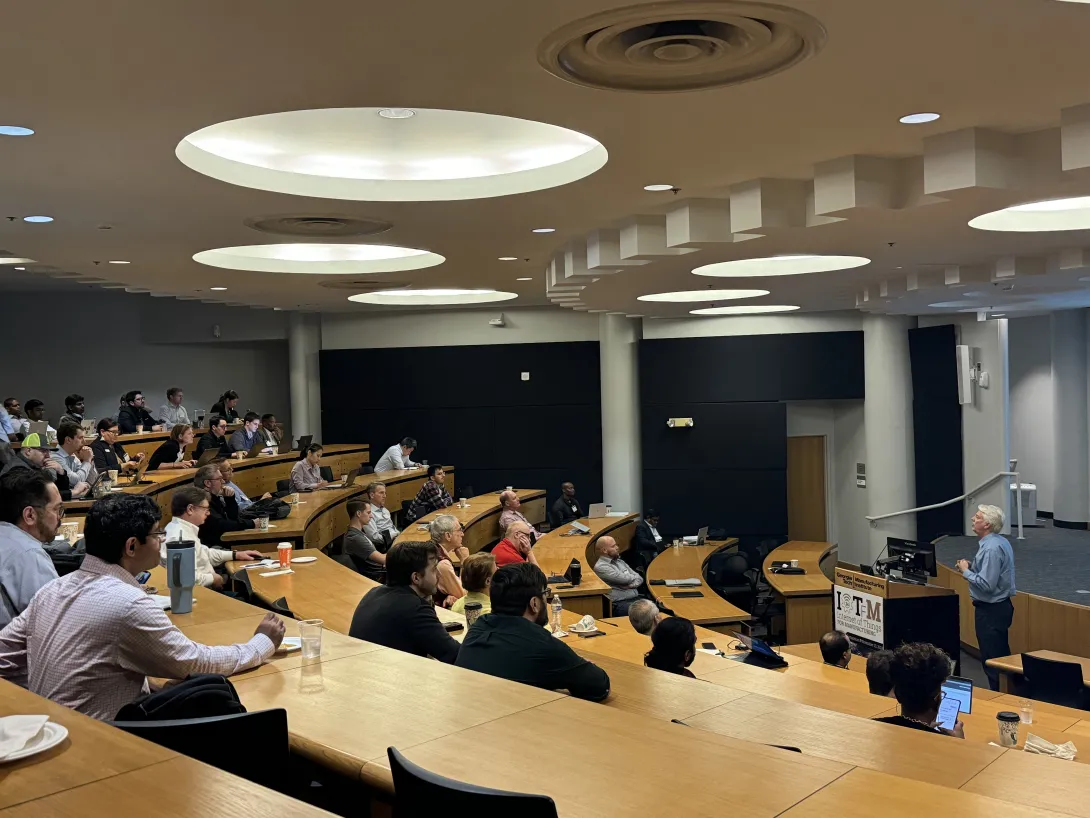 Andrew Dugenske, a principal research engineer at GTMI and symposium organizer, delivering a talk at the symposium&#039;s tenth annual gathering.